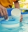 Hand holding white chlorine tablets over swimming pool skimmer. Chlorination of water in pool for disinfection and prevention against the development of microbes. High quality photo